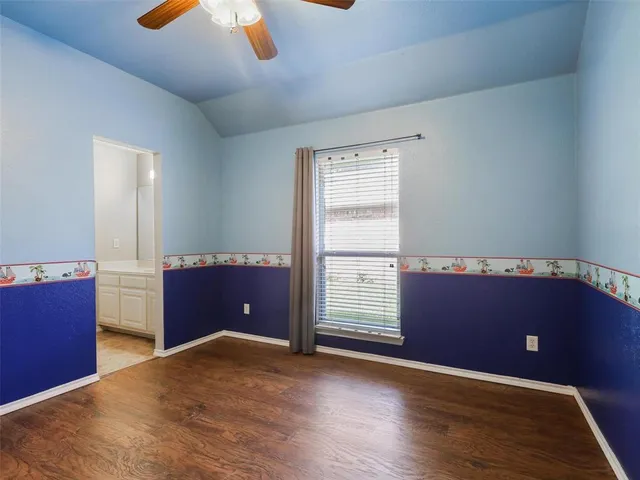 an empty room with windows and cabinet