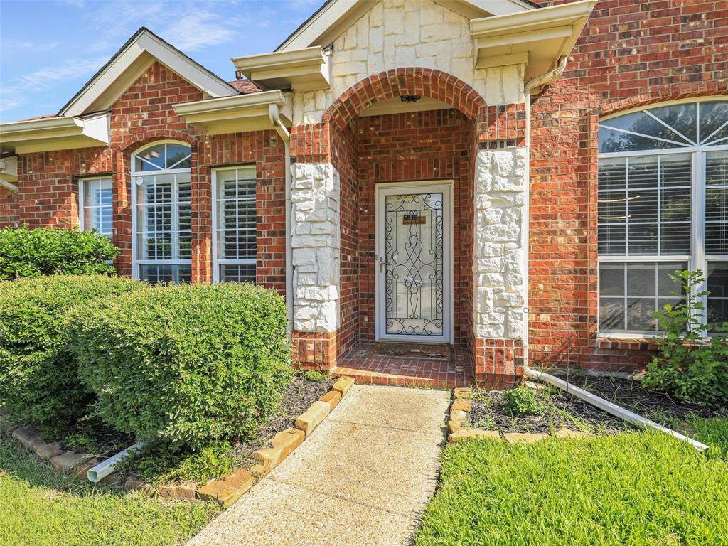 5628 Rock Canyon Road The Colony, TX 75056 - Photo 2 of 24 a front view of a house with garden