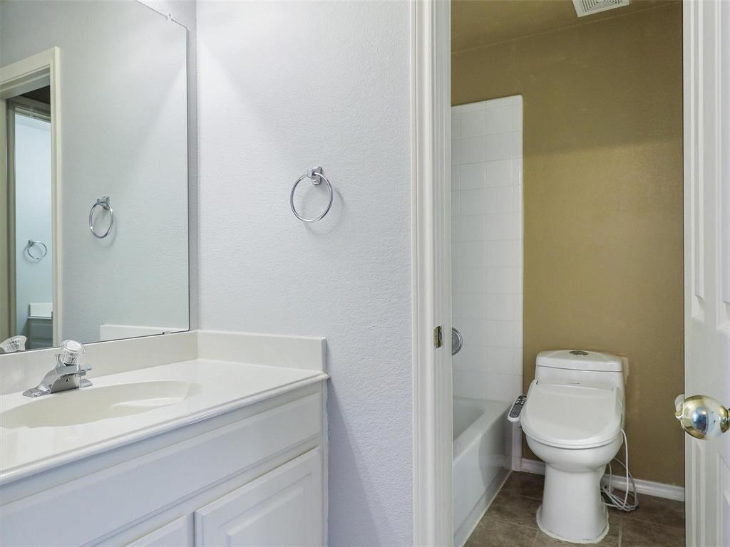 5628 Rock Canyon Road The Colony, TX 75056 - Photo 21 of 24 a bathroom with a sink and a toilet