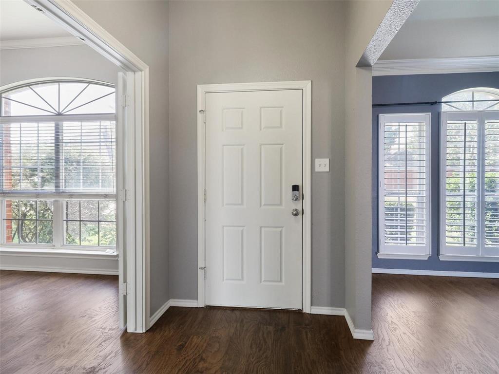 5628 Rock Canyon Road The Colony, TX 75056 - Photo 3 of 24 an empty room with wooden floor and windows with curtains view