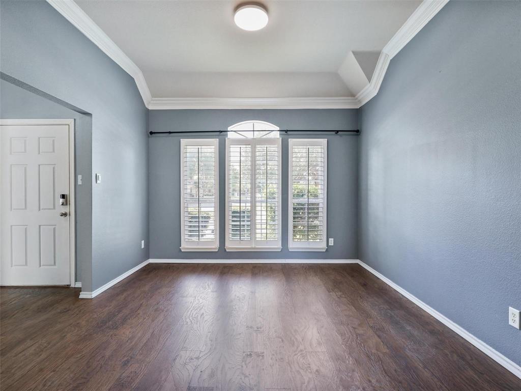5628 Rock Canyon Road The Colony, TX 75056 - Photo 5 of 24 a view of an empty room with wooden floor and a window