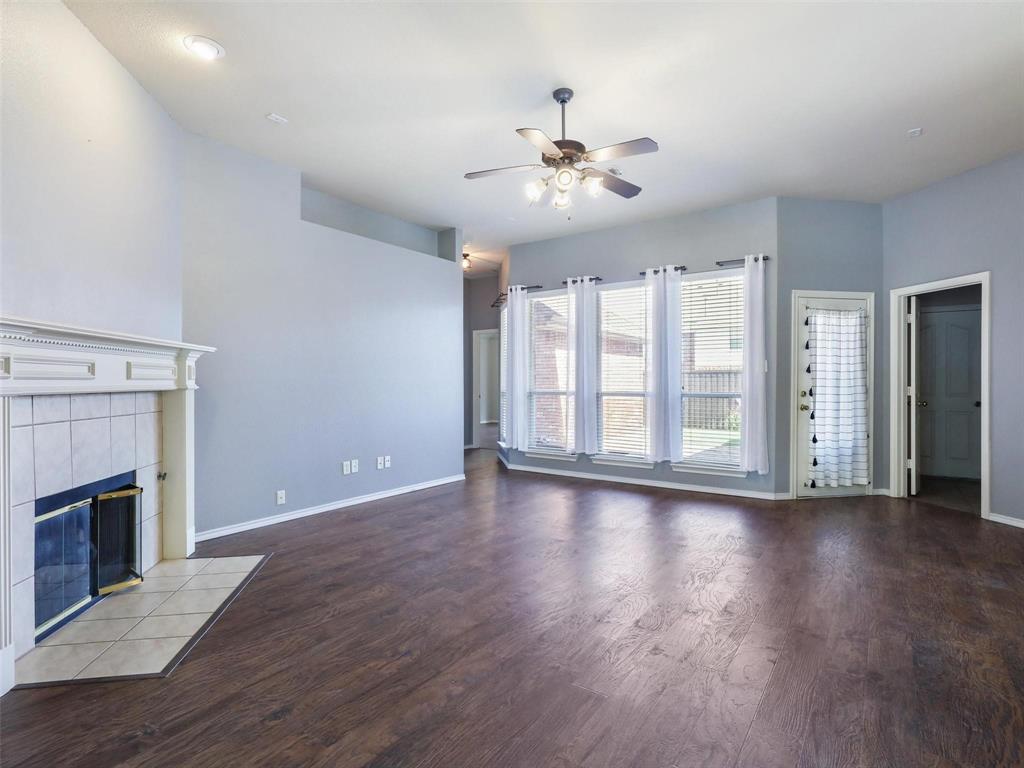 5628 Rock Canyon Road The Colony, TX 75056 - Photo 6 of 24 a view of an empty room with wooden floor and a fireplace