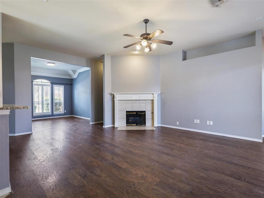 5628 Rock Canyon Road The Colony, TX 75056 - Photo 7 of 24 a view of an empty room with wooden floor and a fireplace