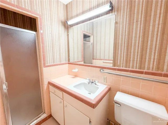 a bathroom with a sink a toilet and a window