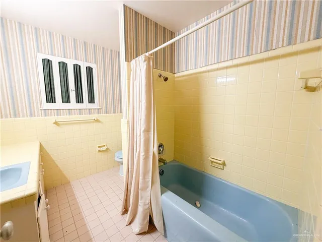 a bathroom with a tub and a shower