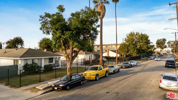 a view of a city street with parked cars
