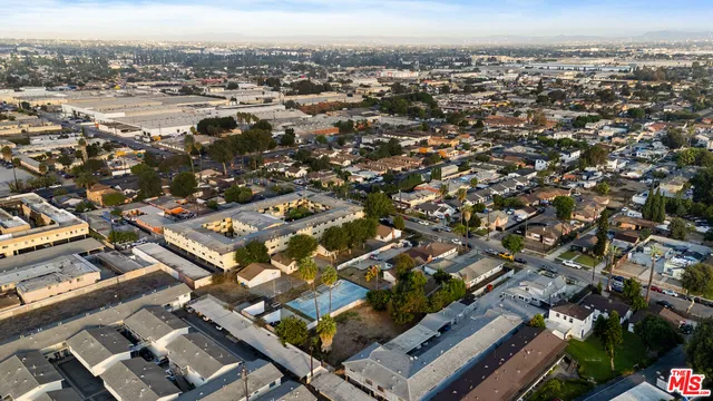 an aerial view of residential building with parking
