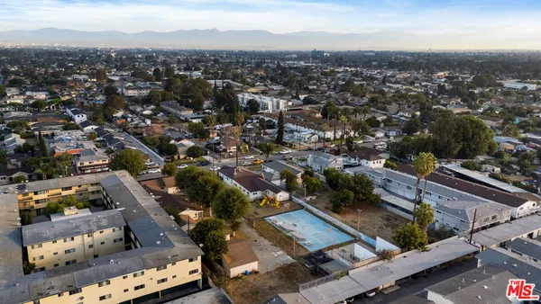 an aerial view of residential houses with city view