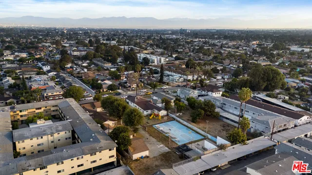 an aerial view of residential houses with city view