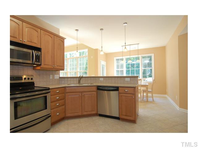 6911 Wexford Woods Trail Raleigh, NC 27613 - Photo 4 of 12 Alternative view of kitchen overlooks breakfast bar and into bright breakfast nook. Home has 9 to 12 foot ceilings throughout!