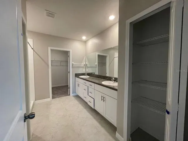 a large bathroom with a sink and a large mirror