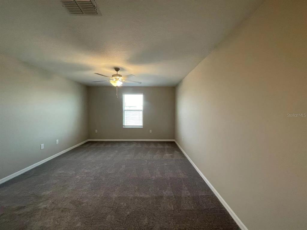 31875 Sun Kettle Loop Wesley Chapel, FL 33545 - Photo 13 of 23 a view of an empty room with a window