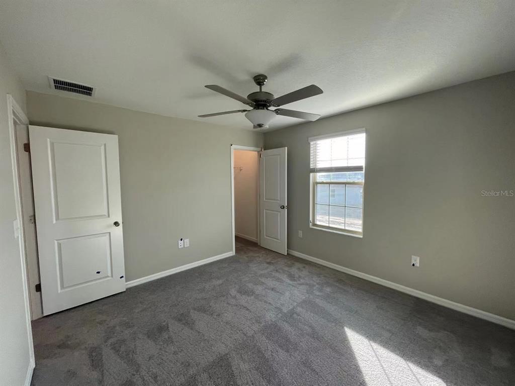 31875 Sun Kettle Loop Wesley Chapel, FL 33545 - Photo 17 of 23 a view of a livingroom with a ceiling fan and window