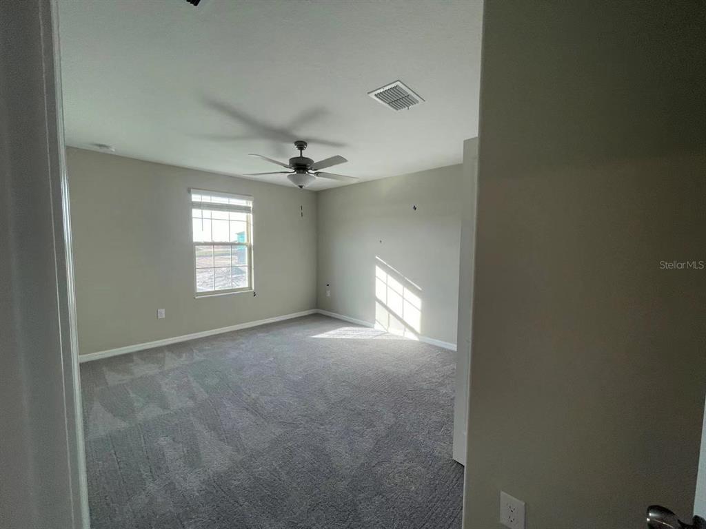 31875 Sun Kettle Loop Wesley Chapel, FL 33545 - Photo 18 of 23 a view of an empty room with a window