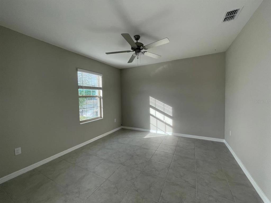 31875 Sun Kettle Loop Wesley Chapel, FL 33545 - Photo 20 of 23 an empty room with windows and fan