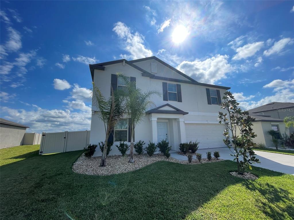 31875 Sun Kettle Loop Wesley Chapel, FL 33545 - Photo 2 of 23 a front view of a house with garden