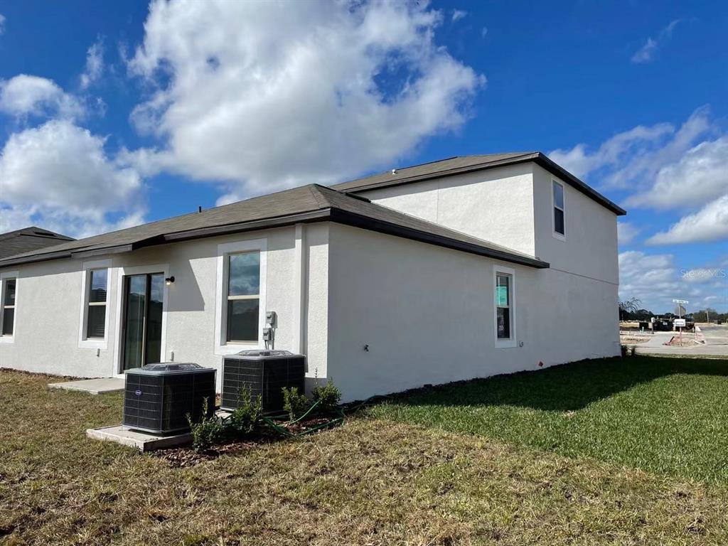 31875 Sun Kettle Loop Wesley Chapel, FL 33545 - Photo 22 of 23 a front view of a house with garden