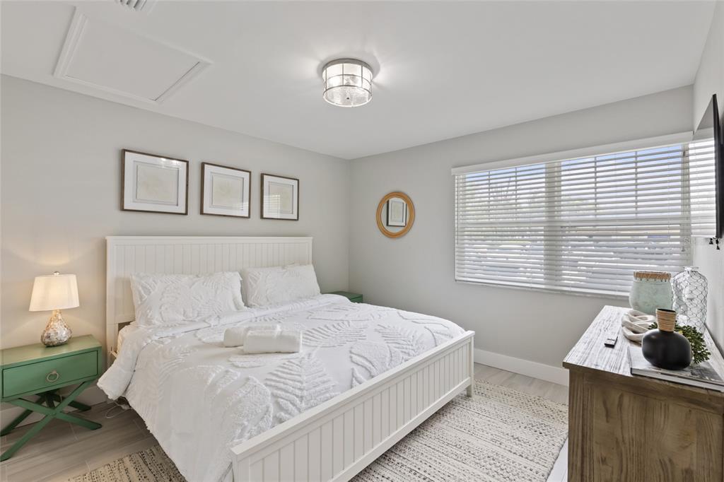 110 Spring Avenue Anna Maria, FL 34216 - Photo 11 of 62 a bedroom with a bed and a window