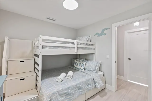 a bathroom with a granite countertop toilet a sink a mirror a shower a vanity and window