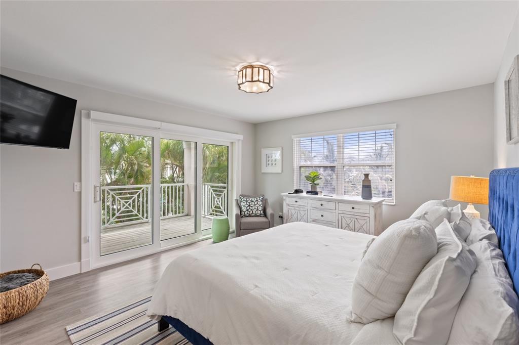110 Spring Avenue Anna Maria, FL 34216 - Photo 18 of 62 a bedroom with a large bed and a large window