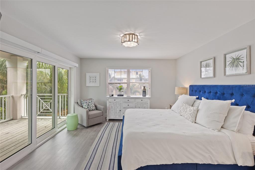 110 Spring Avenue Anna Maria, FL 34216 - Photo 19 of 62 a bedroom with a balcony a bed and a couch