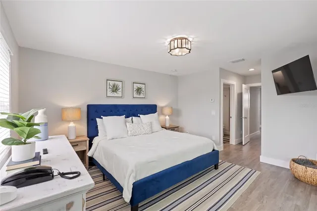 a bedroom with a large bed and a large window