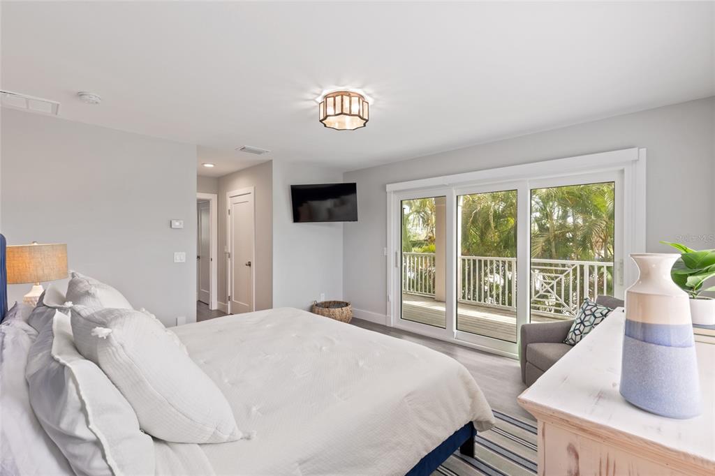110 Spring Avenue Anna Maria, FL 34216 - Photo 22 of 62 a bedroom with a large bed and a large window