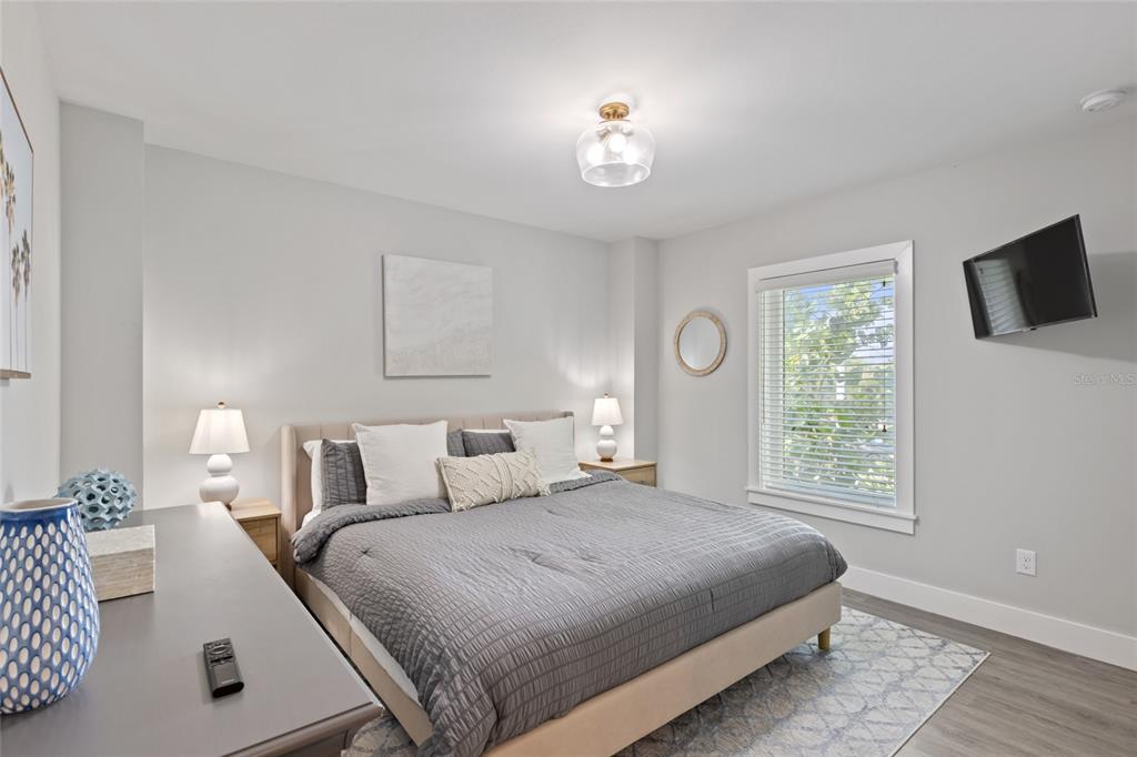 110 Spring Avenue Anna Maria, FL 34216 - Photo 26 of 62 a bedroom with a large bed and a window