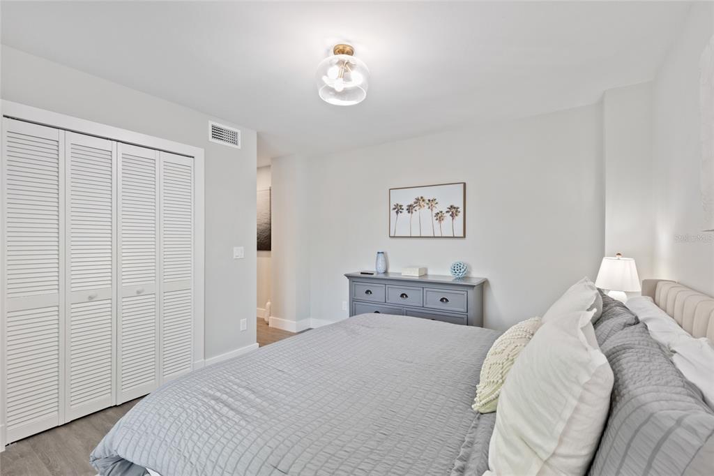 110 Spring Avenue Anna Maria, FL 34216 - Photo 28 of 62 a bed room with a bed and a chandelier