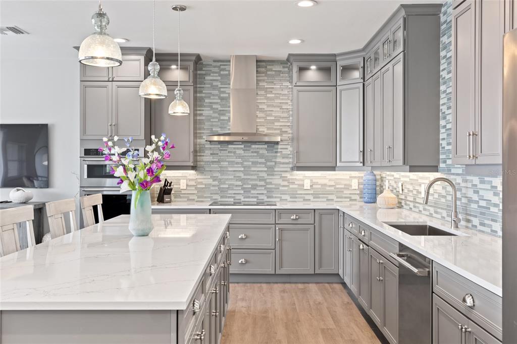 110 Spring Avenue Anna Maria, FL 34216 - Photo 33 of 62 a kitchen with stainless steel appliances granite countertop a sink stove and cabinets