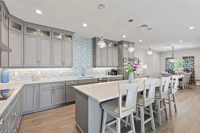 a large white kitchen with a large window