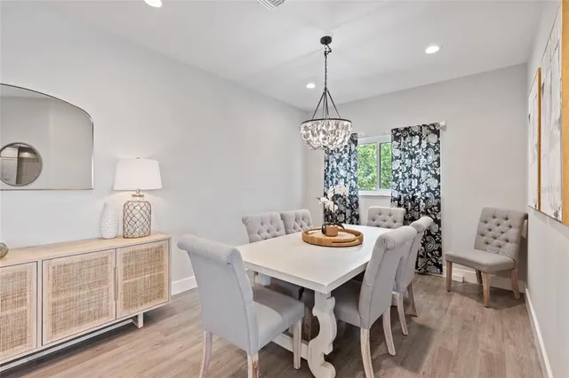 a living room with furniture a flat screen tv and a large window