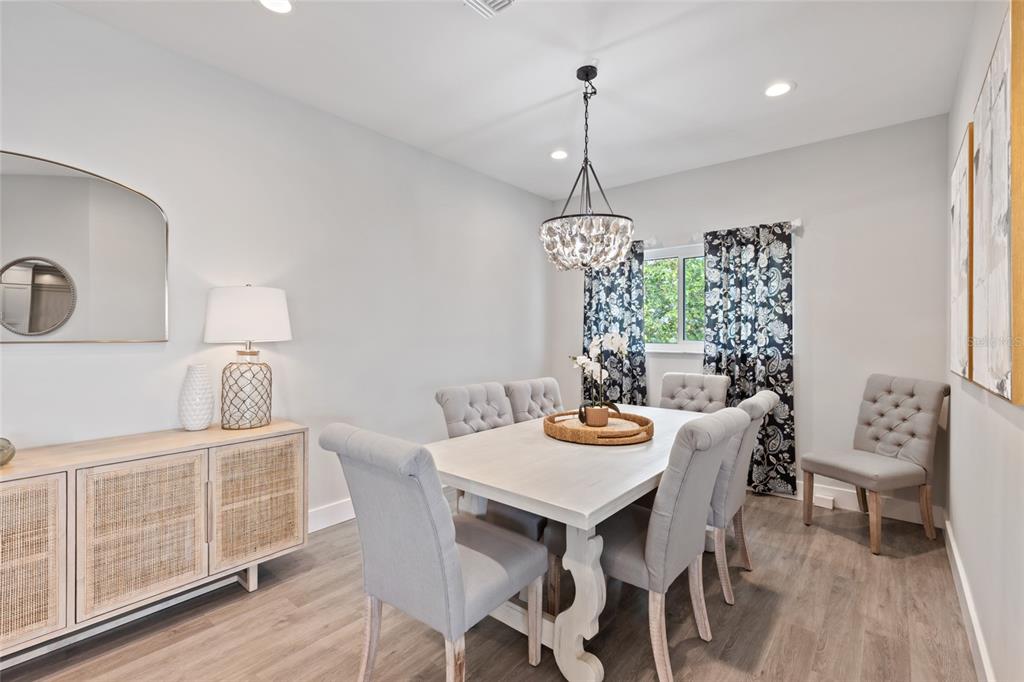 110 Spring Avenue Anna Maria, FL 34216 - Photo 37 of 62 a view of a dining room with furniture window and wooden floor
