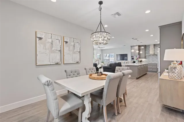 a living room with furniture kitchen and a table