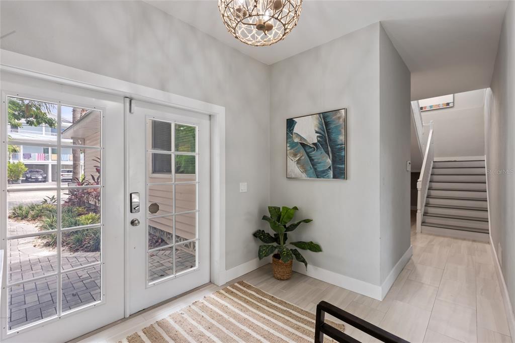 110 Spring Avenue Anna Maria, FL 34216 - Photo 4 of 62 a view of a hallway with wooden floor and a potted plant