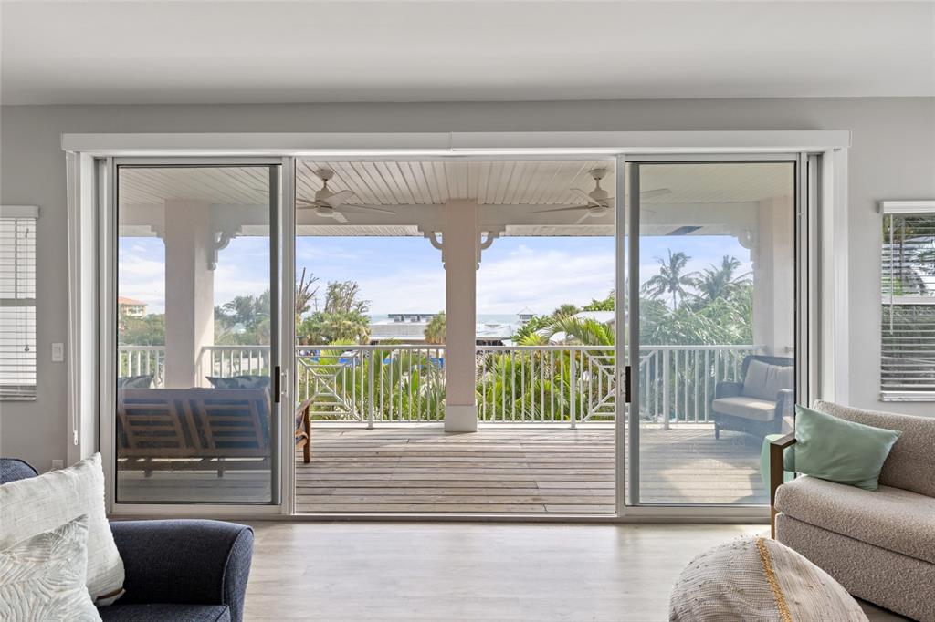 110 Spring Avenue Anna Maria, FL 34216 - Photo 44 of 62 a view of a living room with furniture and floor to ceiling window