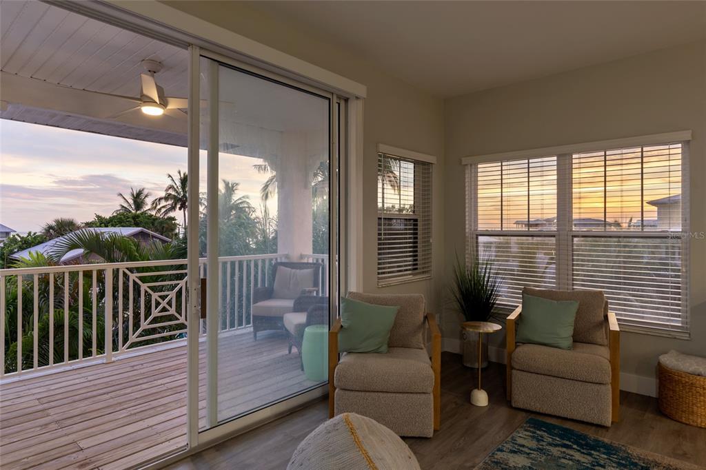 110 Spring Avenue Anna Maria, FL 34216 - Photo 45 of 62 a balcony with furniture and a potted plant