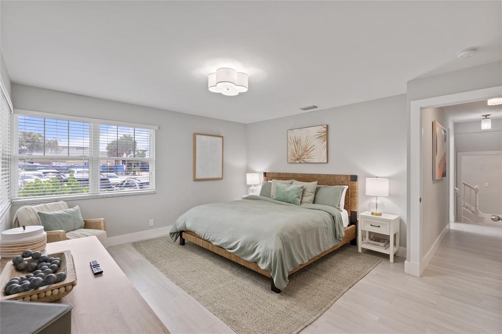 110 Spring Avenue Anna Maria, FL 34216 - Photo 7 of 62 a bedroom with a bed and a window