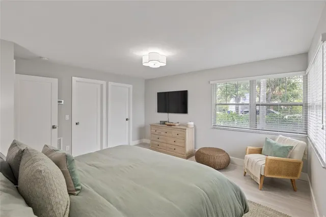 a bathroom with a toilet a sink a mirror and a shower