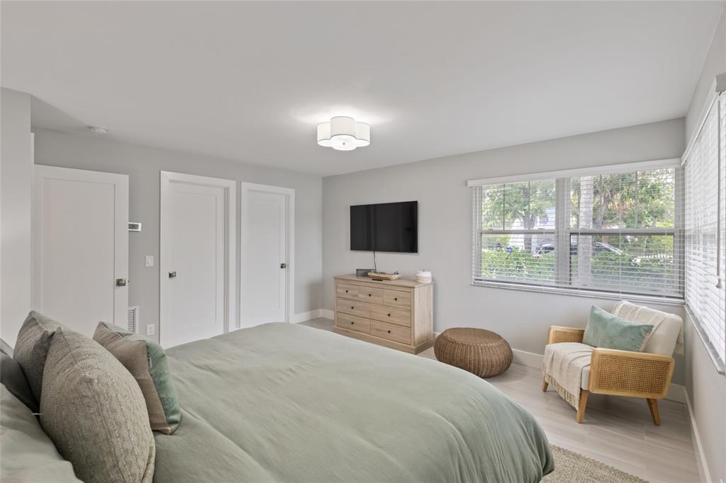 110 Spring Avenue Anna Maria, FL 34216 - Photo 8 of 62 a bedroom with a bed and a flat screen tv