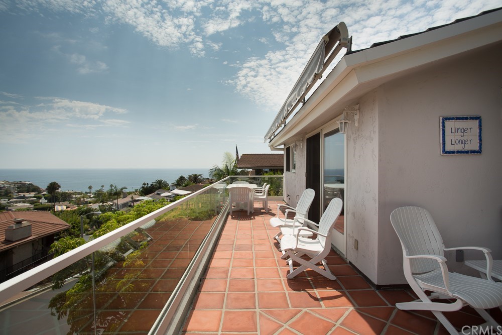 1004 Emerald Bay Laguna Beach, CA 92651 - Photo 2 of 15 a balcony with wooden floor and furniture