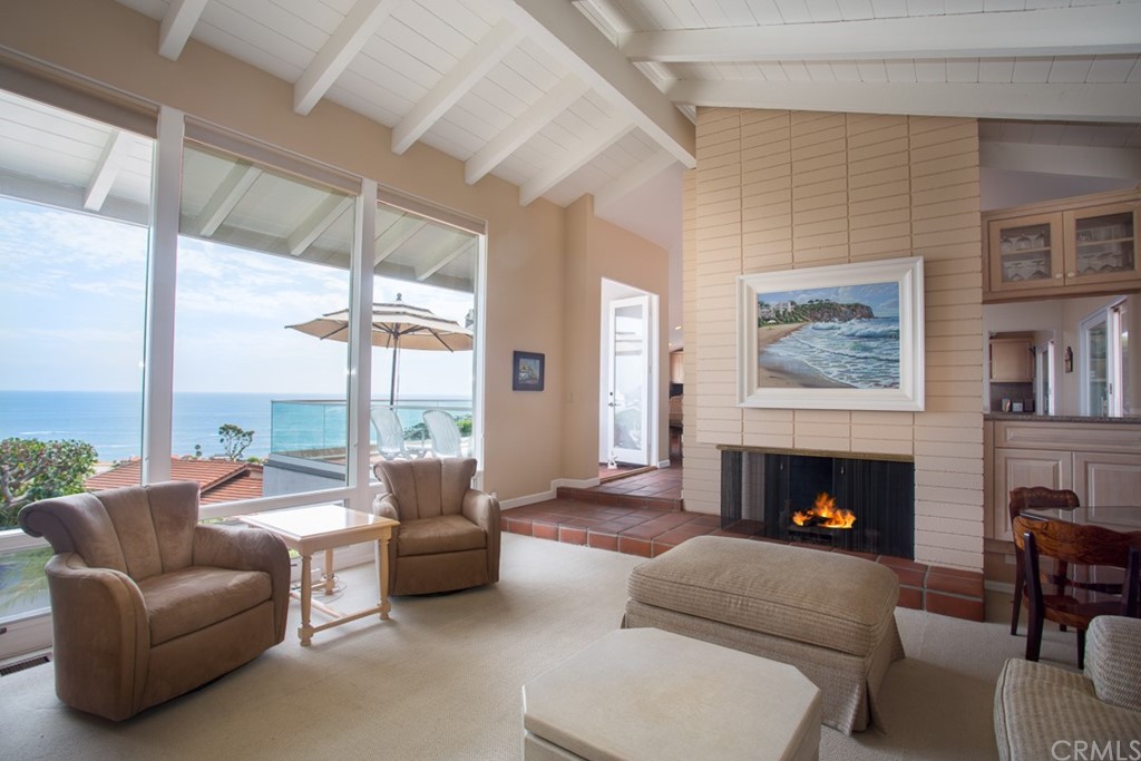 1004 Emerald Bay Laguna Beach, CA 92651 - Photo 7 of 15 a living room with furniture large window and a fireplace