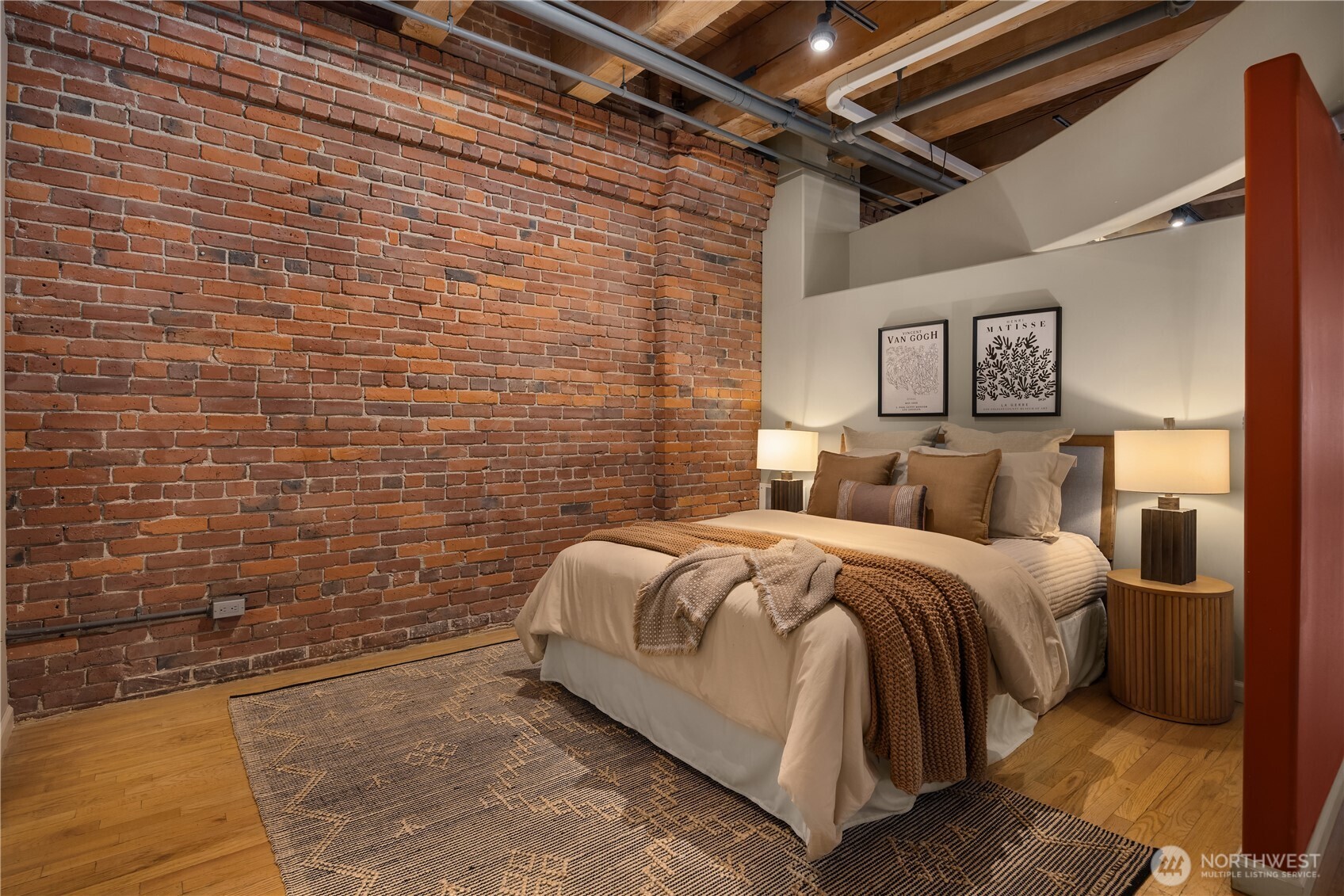 210 3rd Avenue South, Unit 2C Seattle, WA 98104 - Photo 25 of 40 a bed room with a bed and a wall painting