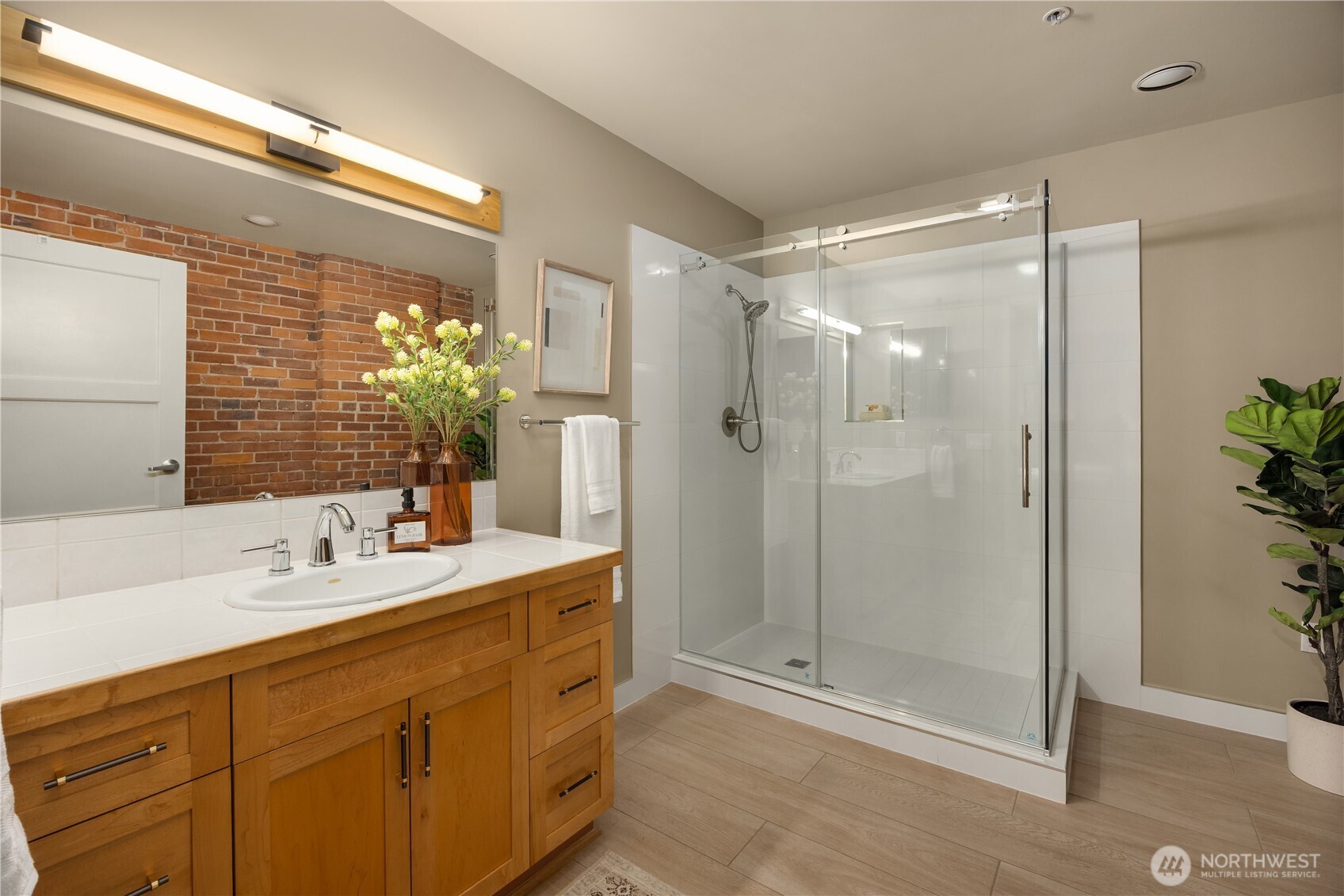 210 3rd Avenue South, Unit 2C Seattle, WA 98104 - Photo 26 of 40 a bathroom with a shower sink and mirror