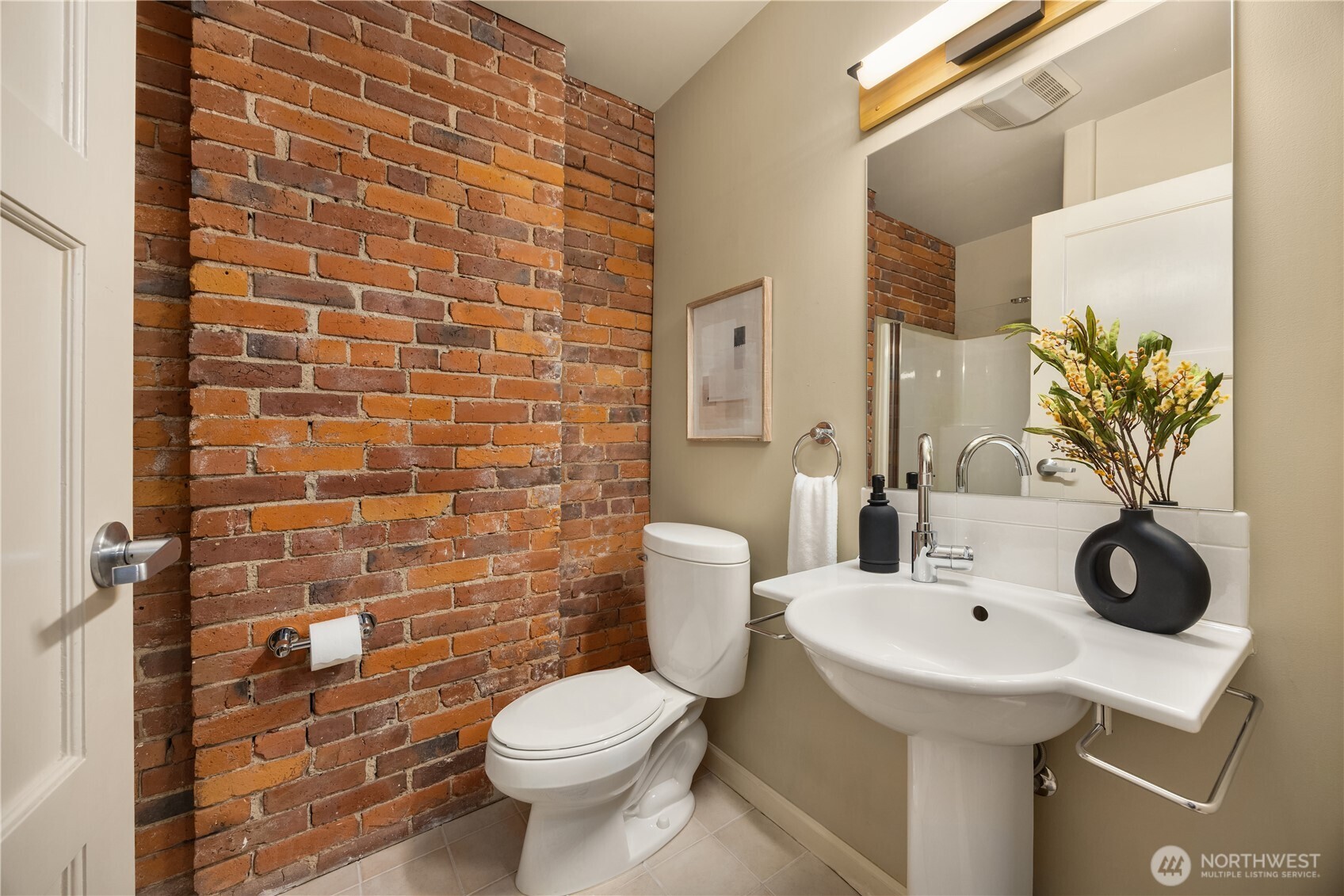 210 3rd Avenue South, Unit 2C Seattle, WA 98104 - Photo 32 of 40 a bathroom with a sink and a mirror