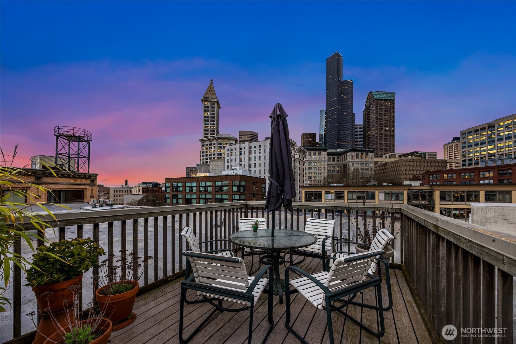 210 3rd Avenue South, Unit 2C Seattle, WA 98104 - Photo 38 of 40 a view of a roof deck with two chairs and a table