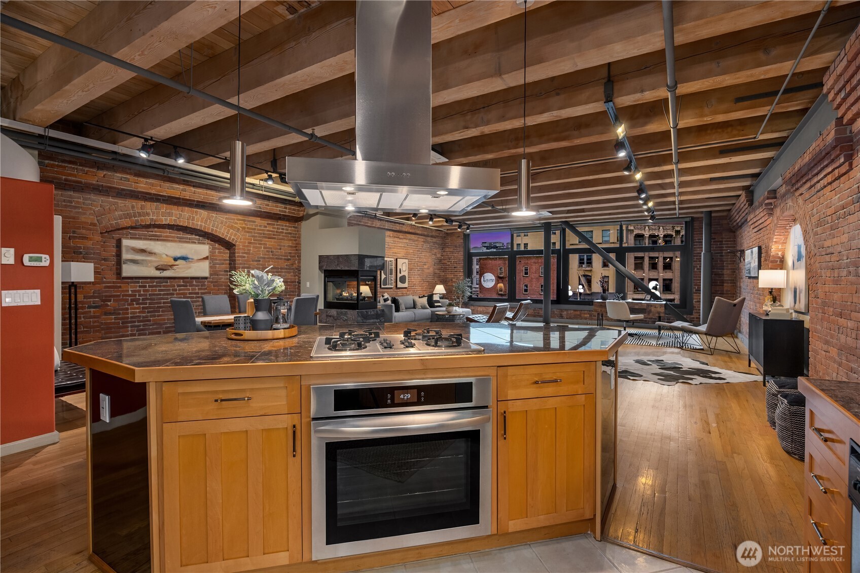 210 3rd Avenue South, Unit 2C Seattle, WA 98104 - Photo 4 of 40 a kitchen with a stove and a wooden floors