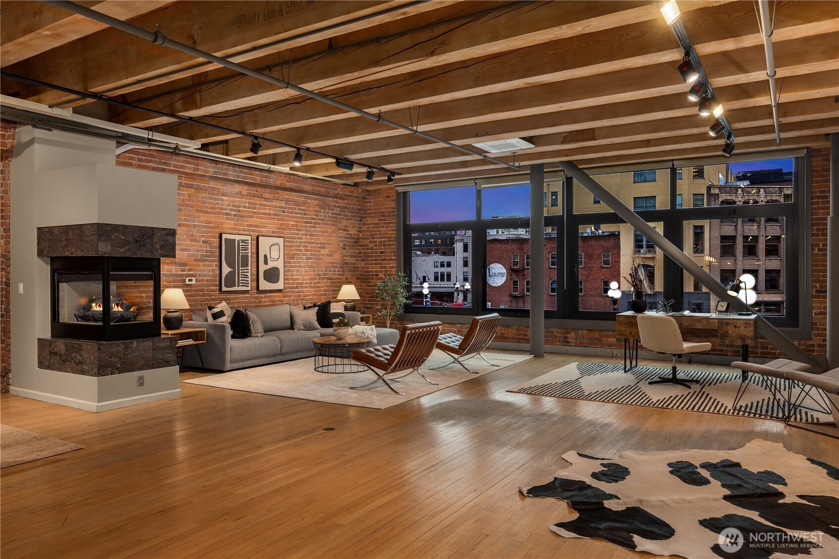 210 3rd Avenue South, Unit 2C Seattle, WA 98104 - Photo 5 of 40 a living room with furniture and a fireplace