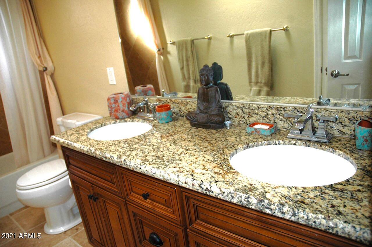 6017 East Rancho Del Oro Drive Cave Creek, AZ 85331 - Photo 14 of 28 a bathroom with a granite countertop sink and a mirror
