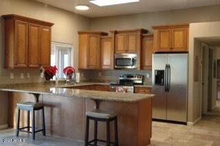 6017 East Rancho Del Oro Drive Cave Creek, AZ 85331 - Photo 2 of 28 a kitchen with stainless steel appliances granite countertop a sink refrigerator and cabinets